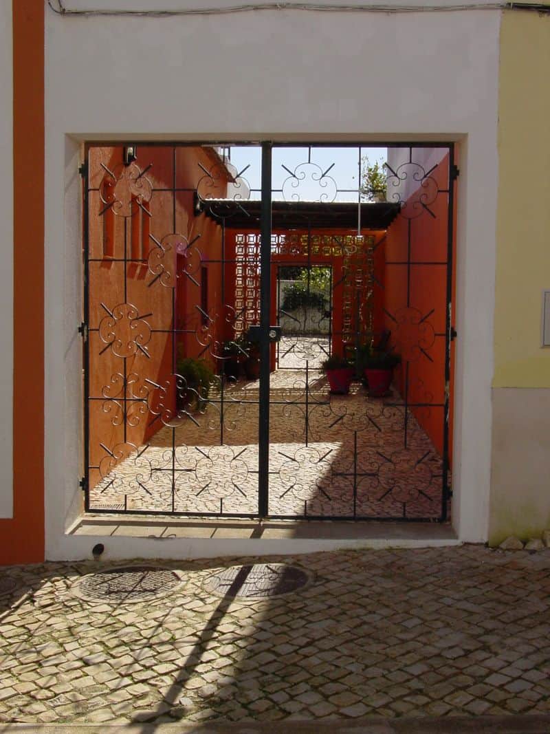 Notice the intricacy evident in both the tile patterns, the iron work in the gate and the masonry wall beyond. 