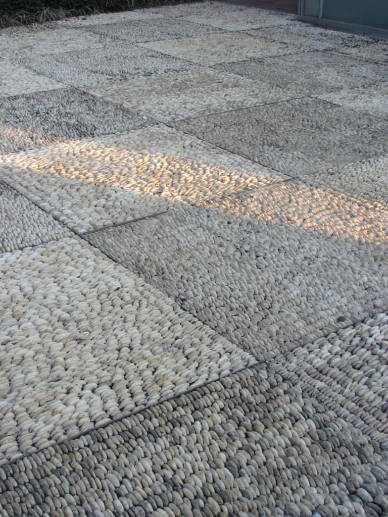 The pebbles turned on edge in this patio hardscape in the Spanish garden are amazing.